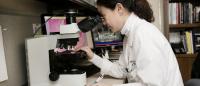 Angela Yoon of Columbia University with microscope